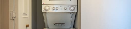 an empty laundry room with a washer and dryer