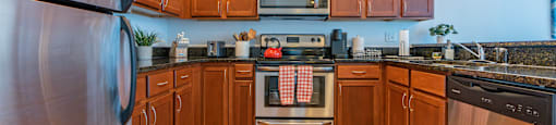 a kitchen with stainless steel appliances and wooden cabinets