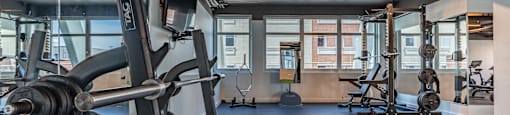 a fitness room with weights and other exercise equipment