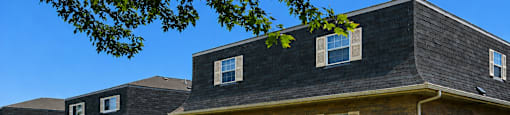 A house with a brown door and a small window.