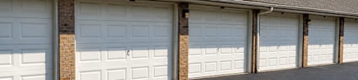 A row of white garage doors are closed.