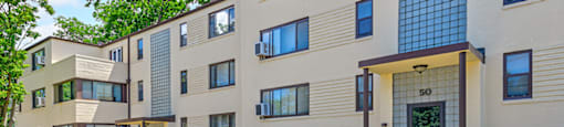 Apartment building number 50 is shown with a red car in the doorway.
