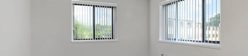 A room with a window and a fan.
