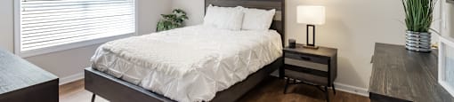 a bedroom with a large bed and a window