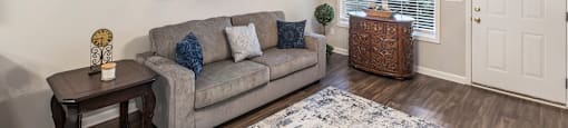 a living room with a couch and a ceiling fan