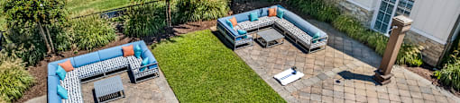A patio with a blue and orange couch.