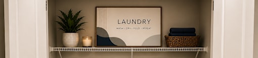 Two front load washing machines in a laundry room.