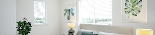 a bedroom with a bed and two windows