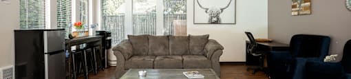 an open living room and dining room with a couch and a coffee table