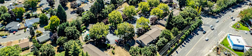 an aerial view of a neighborhood with cars on a highway