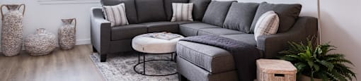3 BR Apartments in Oregon City OR - Timberview Apartments and Townhomes - Living Room with Stylish Decor, a Large Window, White Walls, and Wood-Style Flooring