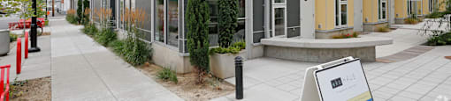 A modern apartment building with a sign in front.