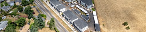 an aerial view of a large commercial building with a highway in front of it