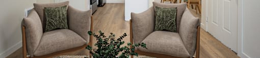 A living room with two chairs and a table.