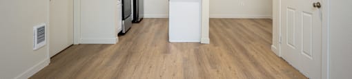 A kitchen area with a white counter and a fridge.