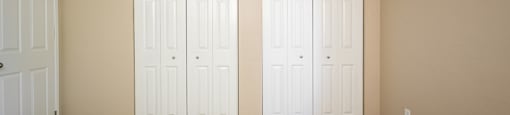 an empty room with two white doors