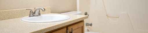 a bathroom with a sink and a toilet and a shower