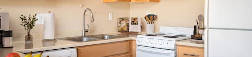 A kitchen with wooden cabinets and a white refrigerator.