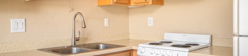 a kitchen with white appliances and wooden cabinets