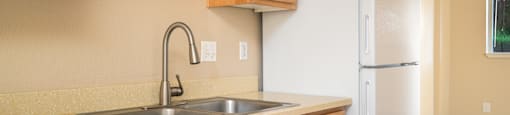 a kitchen with a sink and a refrigerator