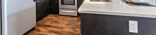 Kitchen with stainless steel appliances and white counter tops at Delo Apartments, Louisville, CO, Colorado, 80027