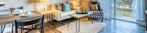 Living room with sliding glass door at Aventine at Lantana - 55+ Active Adult Apartments, Lantana