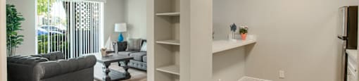 Living room with a bookshelf at Aventine at Lantana - 55+ Active Adult Apartments, Lantana, FL