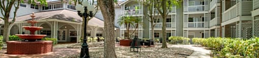 Courtyard with trees at Aventine at Lantana - 55+ Active Adult Apartments, Lantana, FL, 33462