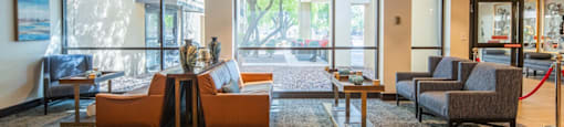 a lobby with couches and chairs and a large window