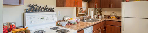 Kitchen with white appliances at Palazzo Senior Apartments - 55+ Active Adult Apartments, Phoenix, Arizona