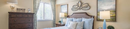 a bedroom with a bed and two dressers