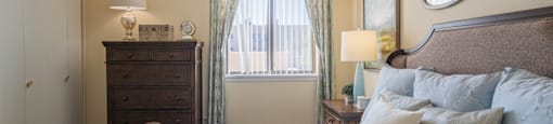 a bedroom with a large bed and a window