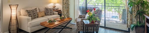a living room with a couch and a table and a balcony