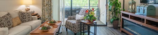 model apartment with couch and table near patio view