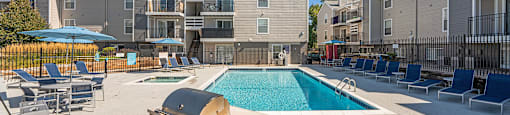 Huntington Apartments pool and BBQ grills and poolside seating
