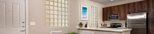a kitchen and dining room with a table and chairs