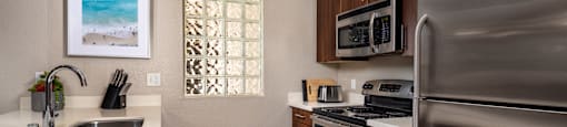a kitchen with stainless steel appliances and a stainless steel refrigerator