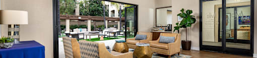 Clubhouse with couches and chairs and a large window