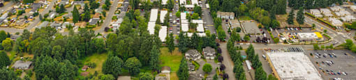 A bird's eye view of a city with a large body of water in the distance.
