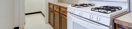 A white stove with a white oven in a kitchen.