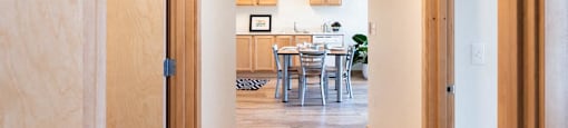 a view of a kitchen and dining room from a doorway at Arbora Court, Seattle, 98105