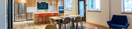 a dining room and kitchen with a table and chairs at Arbora Court, Washington