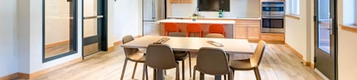 a kitchen and dining room with a table and chairs at Arbora Court, Seattle, 98105
