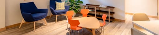 a living room with a table and chairs at Arbora Court, Seattle, Washington