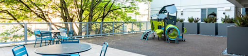 a patio with tables and chairs and a tractor in the background at Arbora Court, Seattle