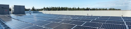 solar panels on the roof of a building at The Aries at Bitter Lake Apartments, Seattle