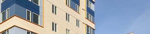 a group of apartment buildings on a city street at The Aries at Bitter Lake Apartments, Seattle