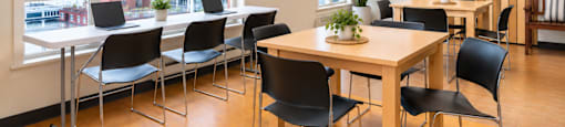 A conference room with a long table and chairs.