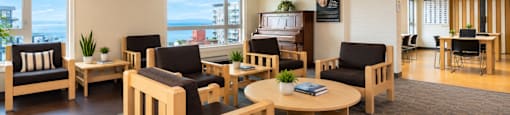 A room with wooden furniture and a carpet.