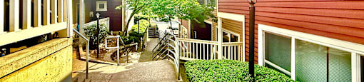 A sunny day in a residential area with houses and greenery.